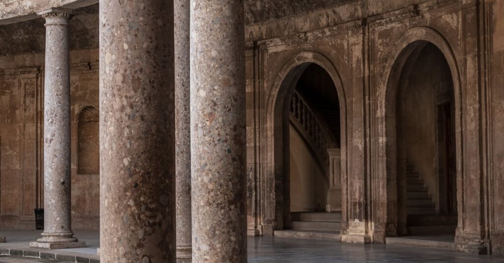 Elegant stone columns and arches in the Alhambra Palace, showcasing classic architecture.